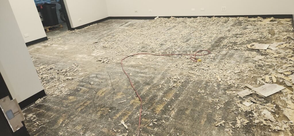 Old flooring removal and concrete prep by F&L Flooring before an epoxy coating